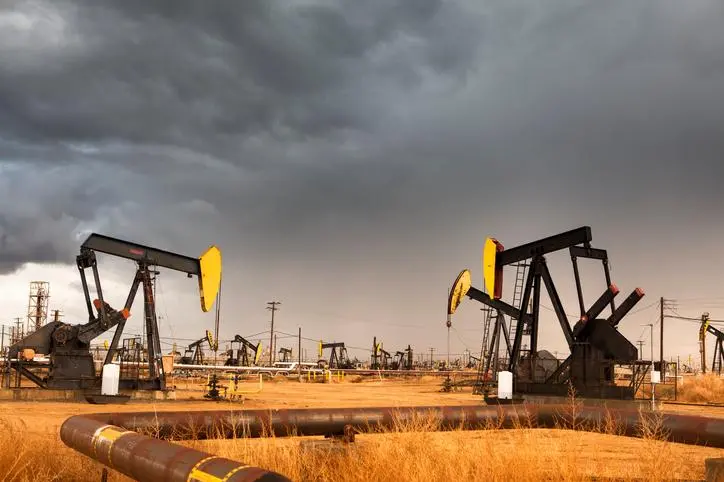 A nodding donkey rig pumps crude up from the ground on an oil field , Getty Images/Getty Images