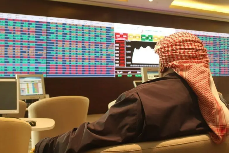 A trader looks at share prices on an electronic display at the Doha Stock Exchange, Qatar January 18, 2016. Naseem Zeitoon, Reuters Image used for illustration purpose , Reuters Images
