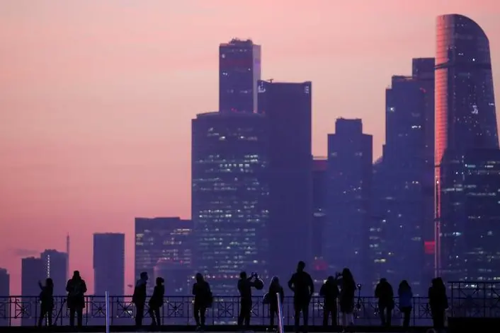 People gather at a view point with Moscow International Business Center, also known as \"Moskva-City\" in the background during sunset in Moscow, Russia April 23, 2019. , Maxim Shemetov