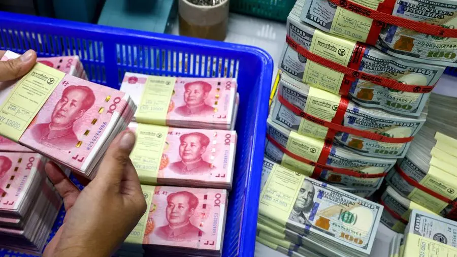 Dollar hovers near two-year high; yuan under threat