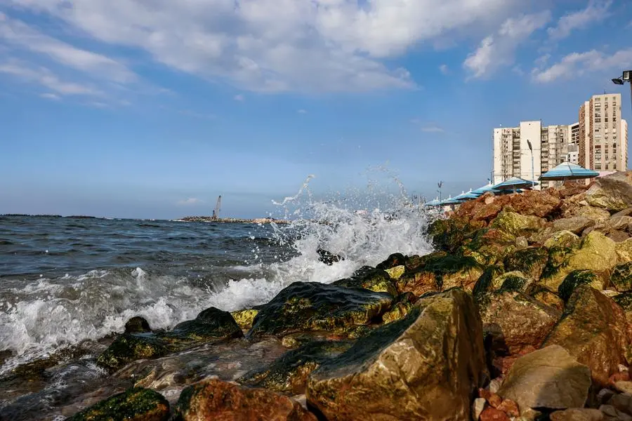 Waves crash along the concrete blocks installed to break them along the Mediterranean sea waterfront in Egypt's northern Mediterranean coastal city of Alexandria on October 31, 2022. - With global warming, rising sea levels and sinking land, Egypt could lose one of its treasures: the second city of Alexandria, along with its historic and ancient ruins. Its millions of inhabitants will have no choice but climate exile. Already, hundreds of Alexandrians have had to leave apartments weakened by flooding, once in 2015 and again in 2020. They are the first of a long line, warns Egypt's ministry of water resources and irrigation. (Photo by Khaled DESOUKI / AFP)
