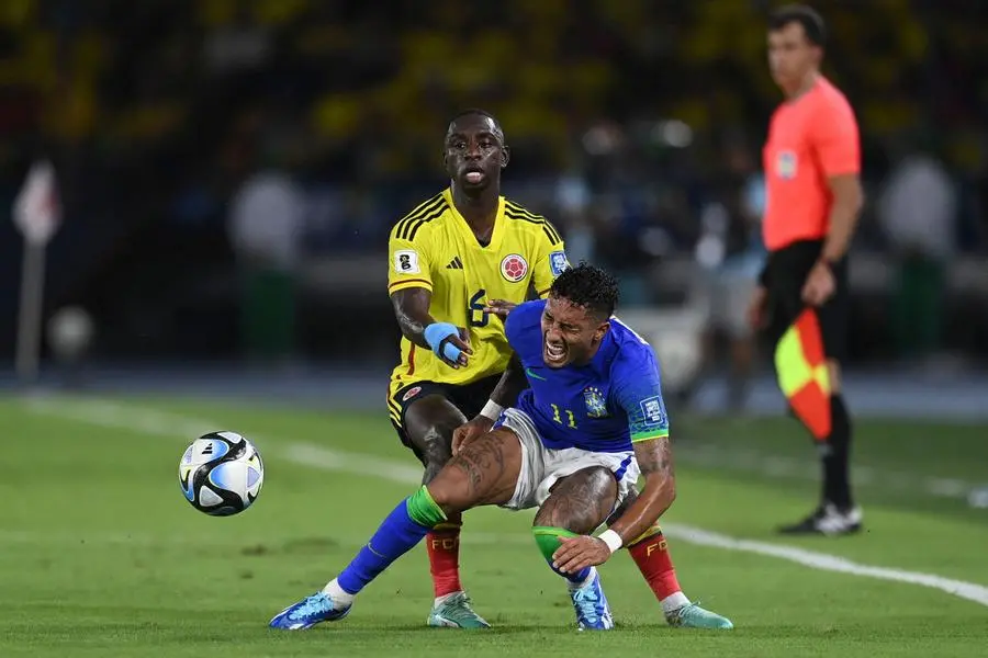 Colombia\\'s defender Deiver Machado (L) and Brazil\\'s forward Raphinha (R) fight for the ball during the 2026 FIFA World Cup South American qualification football match between Colombia and Brazil at the Roberto Melendez Metropolitan Stadium in Barranquilla, Colombia, on November 16, 2023. (Photo by Juan BARRETO / AFP) , Agence France-Presse (AFP)/AFP