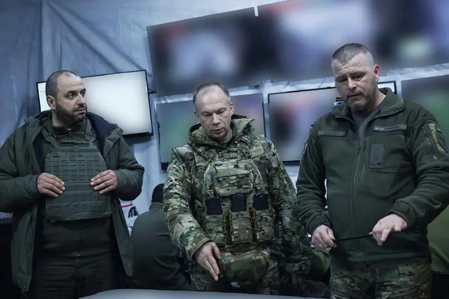This handout photograph released on February 14, 2024, by Press service of Ukrainian Armed Forces, shows Commander-in-Chief of the Armed Forces of Ukraine Oleksandr Syrsky (C) and Ukraine\\'s Defence Minister Rustem Umerov (L) visiting the frontline positions at an undisclosed location in eastern Ukraine. - Newly appointed Ukrainian military chief said on February 14, 2024 that the situation on the front line was precarious, following a visit to positions near Avdiivka and Kupiansk. (Photo by Handout / Armed Forces of Ukraine / AFP)
