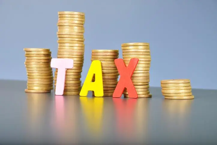 Tax concept with gold stacked coins and alphabet letter. , Getty Images/Getty Images/EyeEm Premium