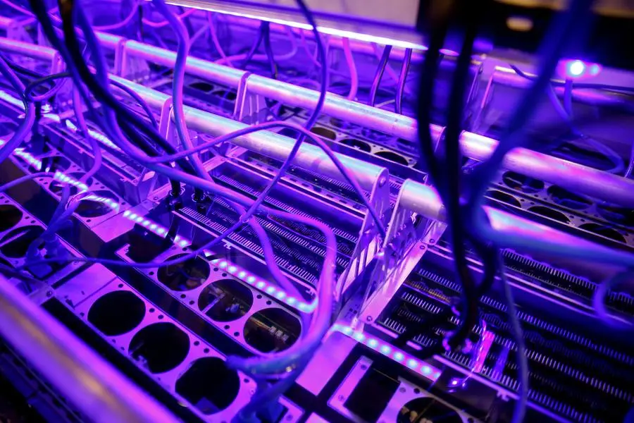 FILE PHOTO: Cryptocurrency miners are seen in a liquid immersion cooling mining tank at the TMG Core stand during the Bitcoin Conference 2022 in Miami Beach, Florida, U.S. April 6, 2022. REUTERS/Marco Bello/File Photo , Reuters