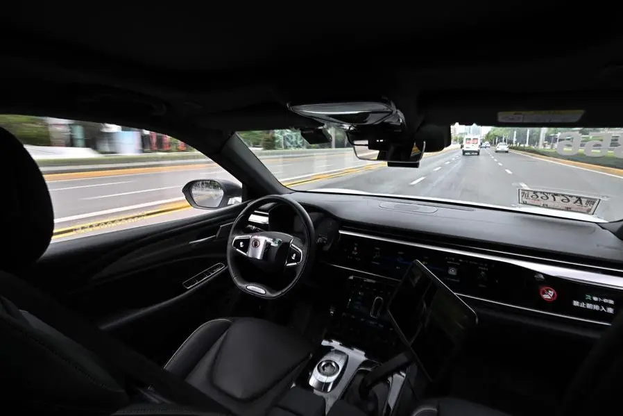 TOPSHOT - The photo taken on August 1, 2024 shows a general view of the driver\\'s seat and controls of a driverless robotaxi autonomous vehicle developed as part of tech giant Baidu\\'s Apollo Go self-driving project, in Wuhan, in central China\\'s Hubei province. Turning heads as they cruise past office buildings and malls, driverless taxis are slowly spreading through Chinese cities, prompting both wariness and wonder. (Photo by Pedro PARDO / AFP) / To go with: CHINA-TECHNOLOGY-AUTOMOTIVE, FOCUS by Jing Xuan TENG , Agence France-Presse (AFP)/AFP
