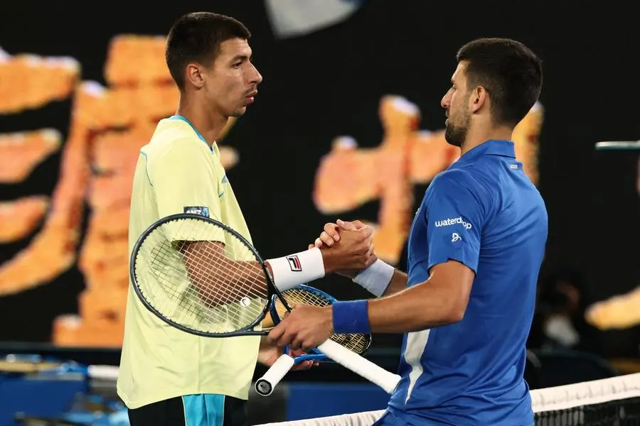 Serbia\\'s Novak Djokovic (R) shakes hands with after Australia\\'s Alexei Popyrin after their men\\'s singles match on day four of the Australian Open tennis tournament in Melbourne on January 17, 2024. (Photo by David GRAY / AFP) / -- IMAGE RESTRICTED TO EDITORIAL USE - STRICTLY NO COMMERCIAL USE -- - -- IMAGE RESTRICTED TO EDITORIAL USE - STRICTLY NO COMMERCIAL USE -- , AFP