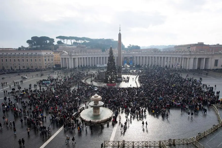 Faithful attend the Angelus prayer led by Pope Francis from his window, at the Vatican, December 31, 2023. Vatican Media/Handout via REUTERS