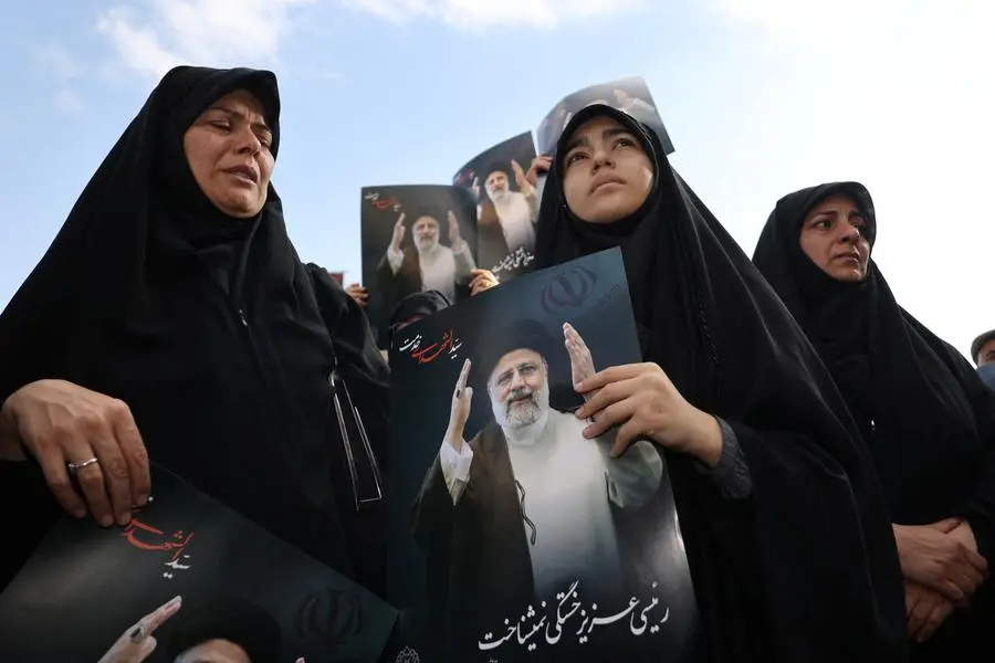 Divided Iran mourns president's death