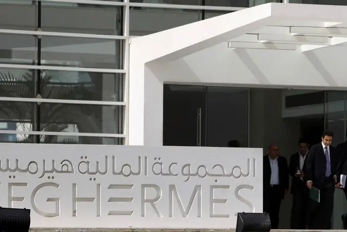 People exit the new headquarters of Egypt-based investment bank EFG-Hermes, on the outskirts of Cairo. Asmaa Waguih. Reuters Images. Image used for illustrative purpose. , Reuters