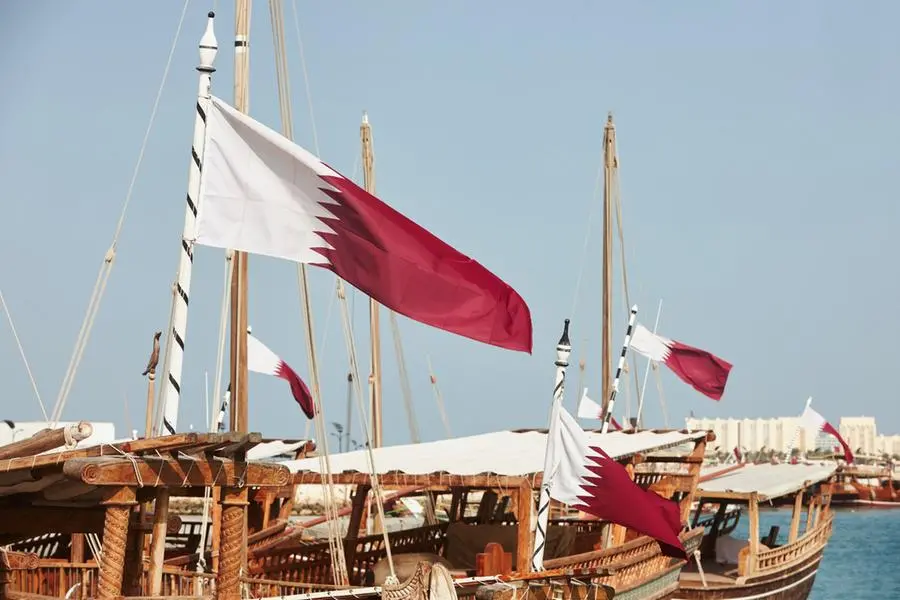 Qatari flags on wooden boats. Traditional dhows moored in Doha. Getty Images Image used for illustrative purpose. , Getty Images