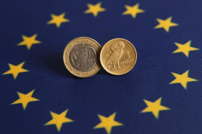 An one Euro (L) and one Greek Drachma coins are displayed on an European flag in this picture illustration taken in Istanbul June 14, 2012. Murad Sezer, Reuters , Reuters Images