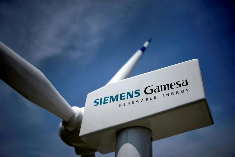FILE PHOTO: A model of a wind turbine with the Siemens Gamesa logo is displayed outside the annual general shareholders meeting in Zamudio, Spain, June 20, 2017. REUTERS/Vincent West , Reuters