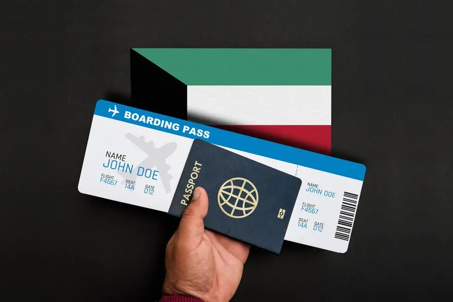 Hand holds passport and boarding pass with flag of Kuwait. Image used for illustrative purpose Getty Images , Getty Images