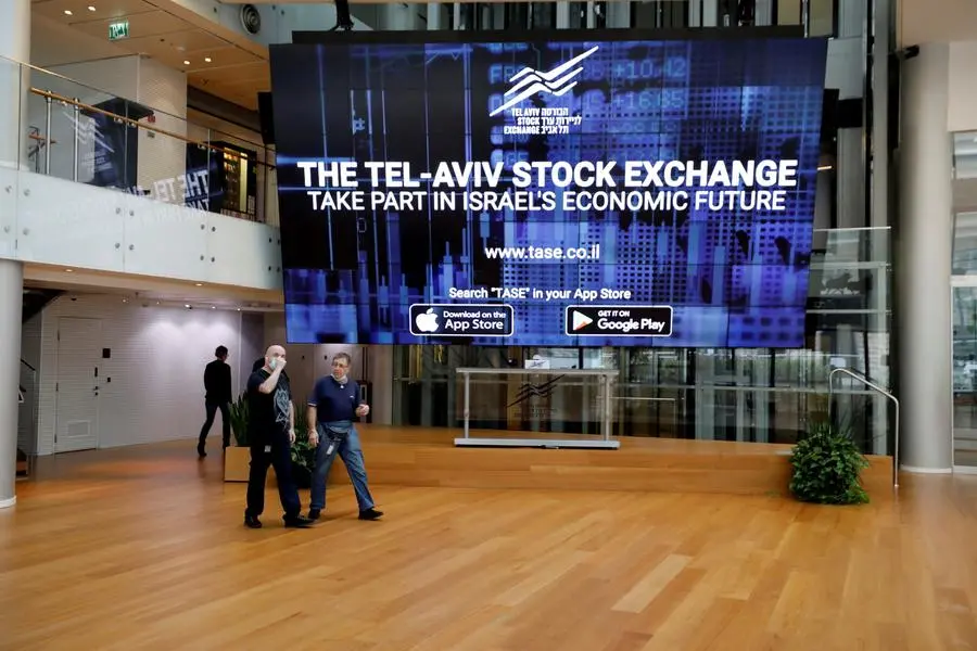 FILE PHOTO: Men walk past an electronic board at the Tel Aviv Stock Exchange, in Tel Aviv, Israel November 4, 2020. Picture taken November 4, 2020. REUTERS/Amir Cohen/File Photo Image used for illustrative purpose. , Reuters/REUTERS