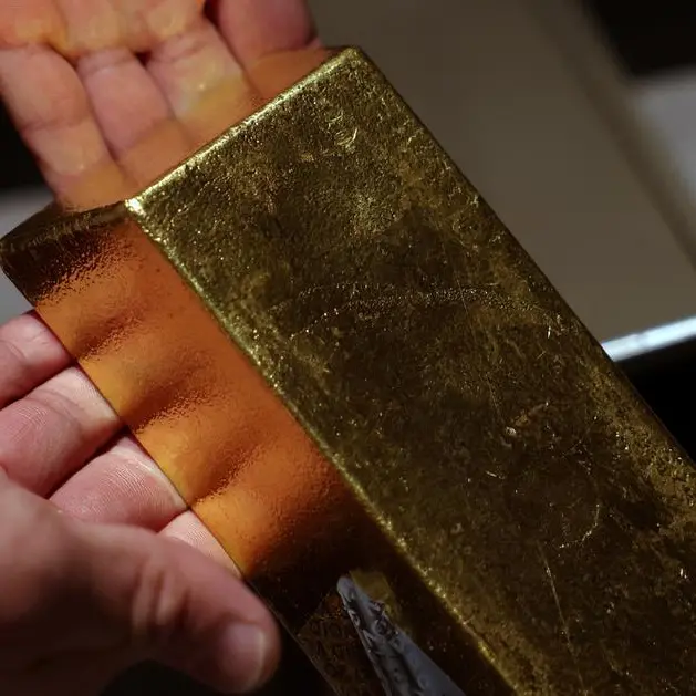 Gold rises on bargain hunting and US rate cut, set for monthly gain