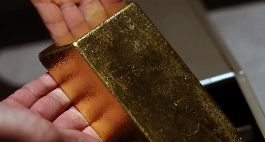 Gold rises on bargain hunting and US rate cut, set for monthly gain