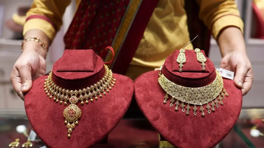 Gold briefly dips below $5,000 as Fed speculation drives sharp pullback