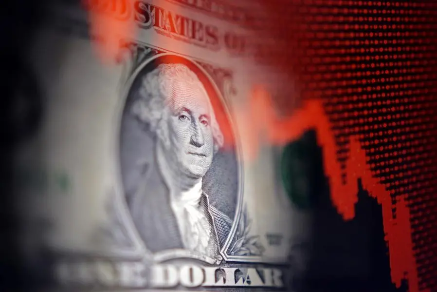U.S. dollar banknote and decreasing stock graph are seen in this illustration taken April 25, 2025. REUTERS/Dado Ruvic/Illustration. , Reuters