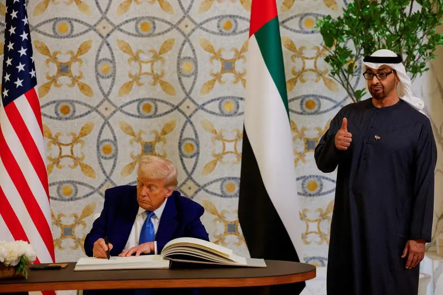 U.S. President Donald Trump signs a guest book next to United Arab Emirates President Sheikh Mohamed bin Zayed Al Nahyan, at Qasr Al Watan, in Abu Dhabi, United Arab Emirates, May 15, 2025. REUTERS/Brian Snyder TPX IMAGES OF THE DAY , Reuters/REUTERS