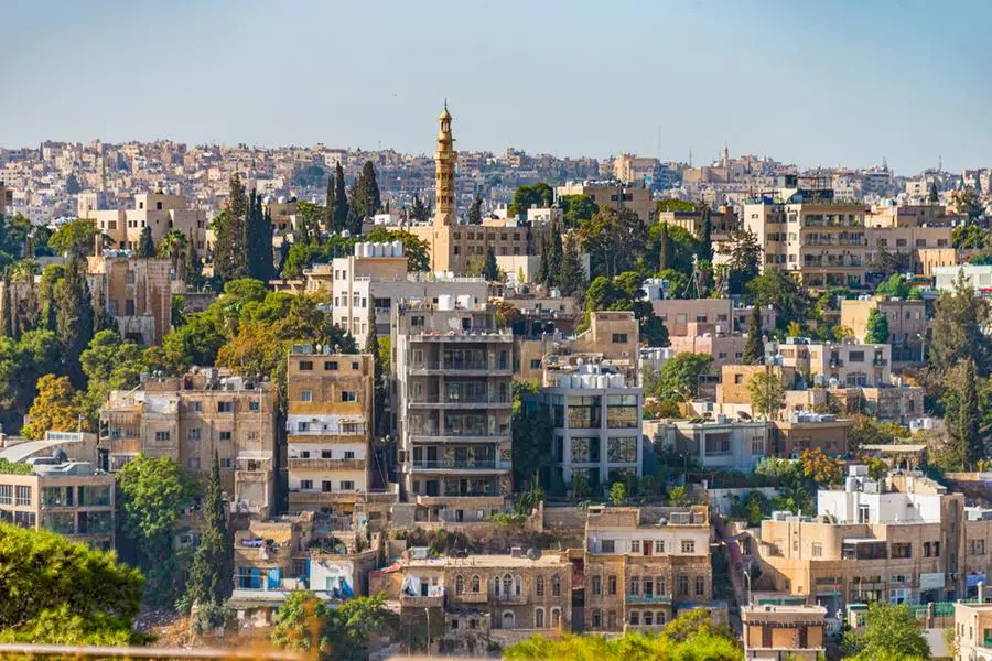 The panoramic view of the native architectural homes and buildings in Amman Citadel, Jordan, surrounded by green trees over the skyline - October 14, 2015. Image used for illustrative purpose. Getty Images , Getty Images