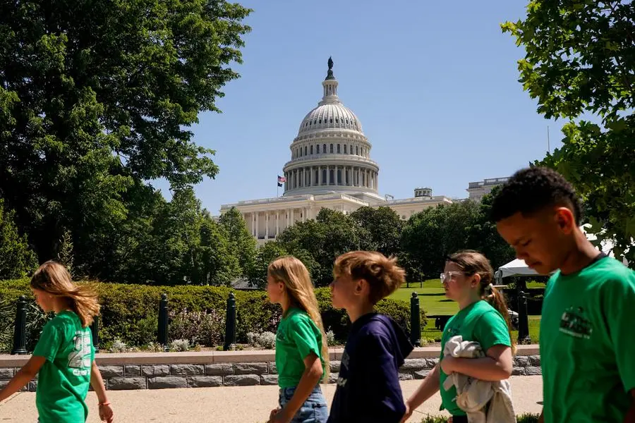 FILE PHOTO: People walk near the Capitol as the U.S. House of Representatives considers U.S. President Donald Trump\\'s sweeping tax-cut bill on Capitol Hill in Washington, D.C., U.S., May 19, 2025. REUTERS/Nathan Howard. , Reuters