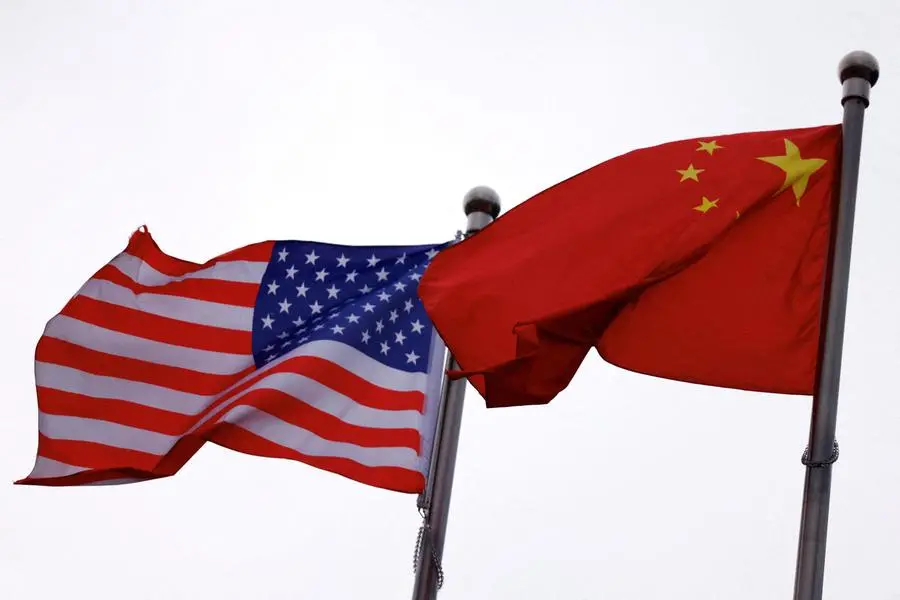 FILE PHOTO: Chinese and U.S. flags flutter outside the building of an American company in Beijing, China April 8, 2025. REUTERS/Tingshu Wang. , Reuters