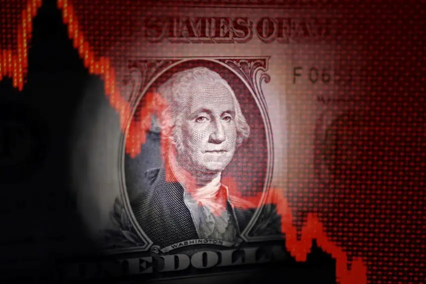 U.S. dollar banknote and decreasing stock graph are seen in this illustration taken April 25, 2025. REUTERS/Dado Ruvic/Illustration. , Reuters