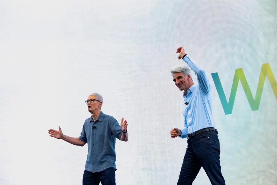 Apple CEO Tim Cook and Senior Vice President of Software Engineering Craig Federighi speak during Apple\\'s annual World Wide Developers Conference at the company\\'s headquarters in Cupertino, California, U.S., June 9, 2025. REUTERS/Laure Andrillon. , Reuters