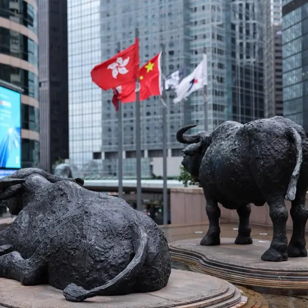 Shares edge higher in Asia as oil dips, earnings loom