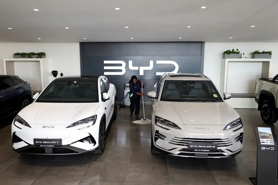 Amukelani Masungi, a worker, cleans the floor next to BYD vehicles on display at a BYD dealership in Sandton, South Africa, June 5, 2025. REUTERS/Siphiwe Sibeko. , Reuters