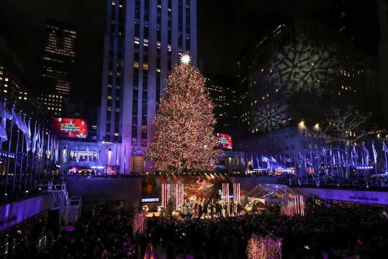 People watch the lighting of The Rockefeller Center Christmas Tree in New York City, U.S., December 4, 2019. REUTERS/Jeenah Moon - RC2ROD997UDJ , Reuters Images