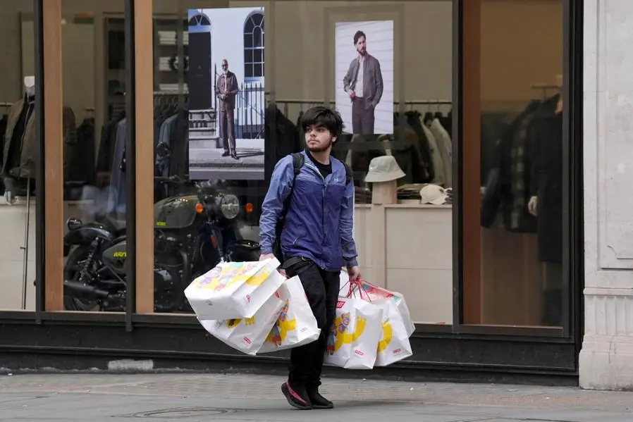 FILE PHOTO: Shopper carrying Pop Mart bags walks on Regent Street, in London, Britain, May 15, 2025. REUTERS/ Maja Smiejkowska. , Reuters