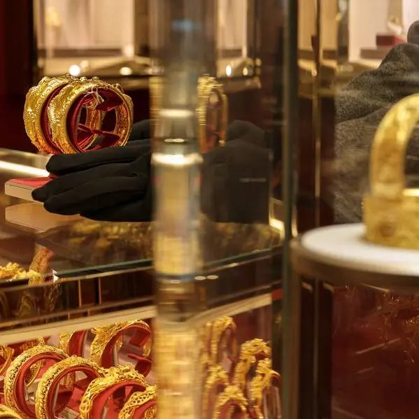 Gold edges down as dollar firms; inflation data in focus