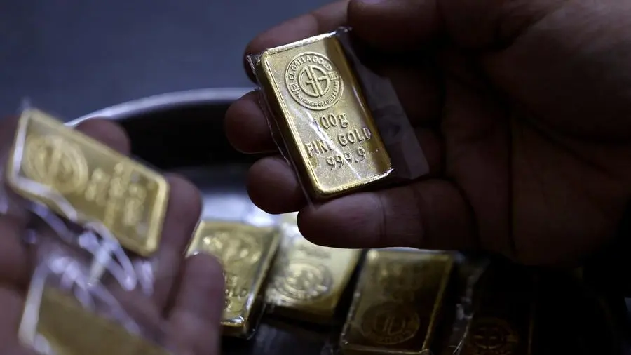 Gold set for third weekly fall on hawkish US Fed, elevated dollar