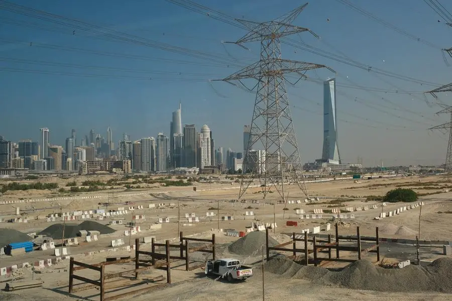 DUBAI, UNITED ARAB EMIRATES - DECEMBER 07: In this view through a metro train window high-rise buildings stand behind electricity power lines and a transmission tower on December 07, 2023 in Dubai, United Arab Emirates. (Photo by Sean Gallup/Getty Images). Image used for illustrative purpose. Getty Images , Getty Images