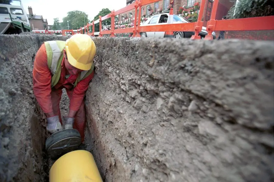 Public Utilities, Operative blocking off the end of a polyethylene gas pipe in a trench. (Photo by Jean-Francois Cardella/Construction Photography/Avalon/Getty Images). Image used for illustrative purpose , Getty Images