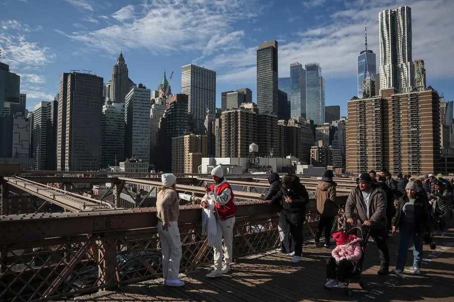 People walk along the Brooklyn Bridge in Manhattan in New York City, U.S., December 26, 2024. REUTERS/Marko Djurica. , Reuters