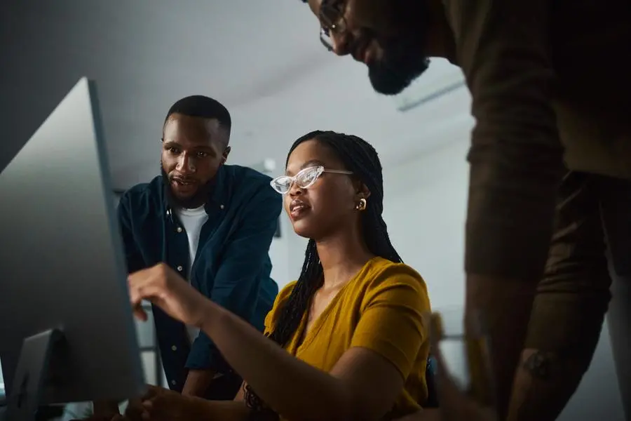 A motivated entrepreneurs working tirelessly at a desktop computer, showcasing their dedication to success. Their focused expressions and engaged body language convey their commitment to accomplishing their goals even during late hours. Image used for illustrative purpose. Getty Images , Getty Images