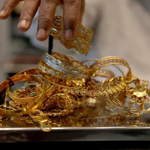 Gold set for third weekly loss amid stronger dollar, reduced Fed rate cut hopes