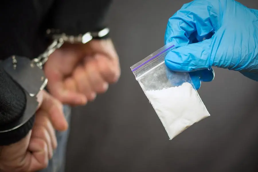A police officer finds drugs during the search of drug dealers. Image used for illustrative purpose. Getty Images