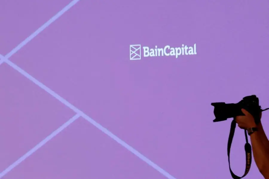 FILE PHOTO: The logo of Bain Capital is displayed on the screen during a news conference in Tokyo, Japan October 5, 2017. REUTERS/Kim Kyung-Hoon. , Reuters