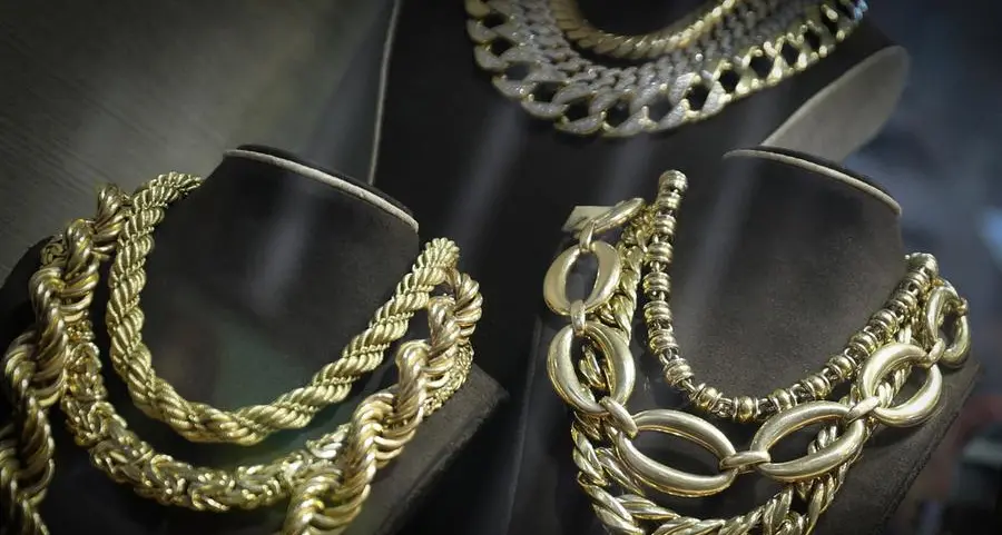 Gold holds above $5,000 on softer dollar; investors brace for US data