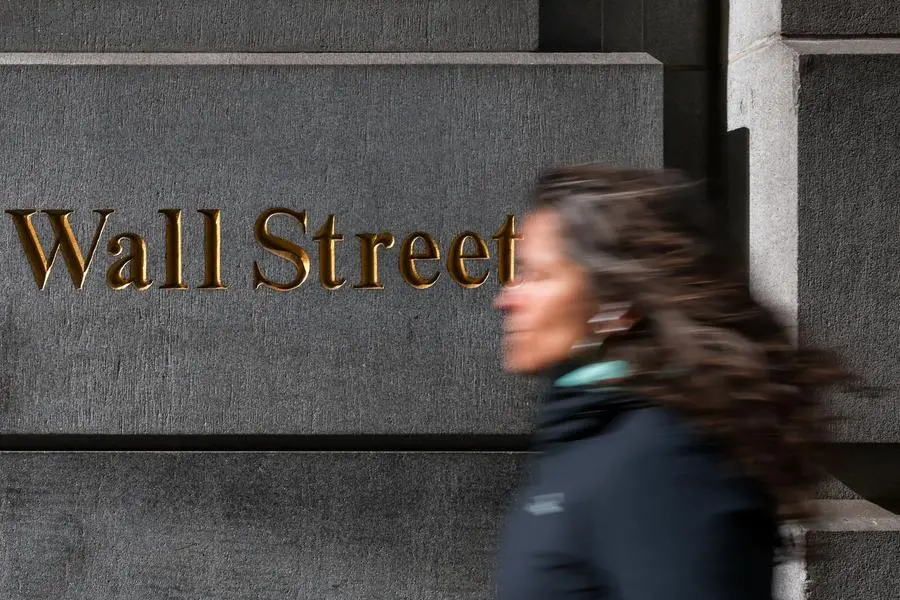 A woman walks down Wall Street in New York City, U.S., April 8, 2025. REUTERS/Kylie Cooper. , Reuters
