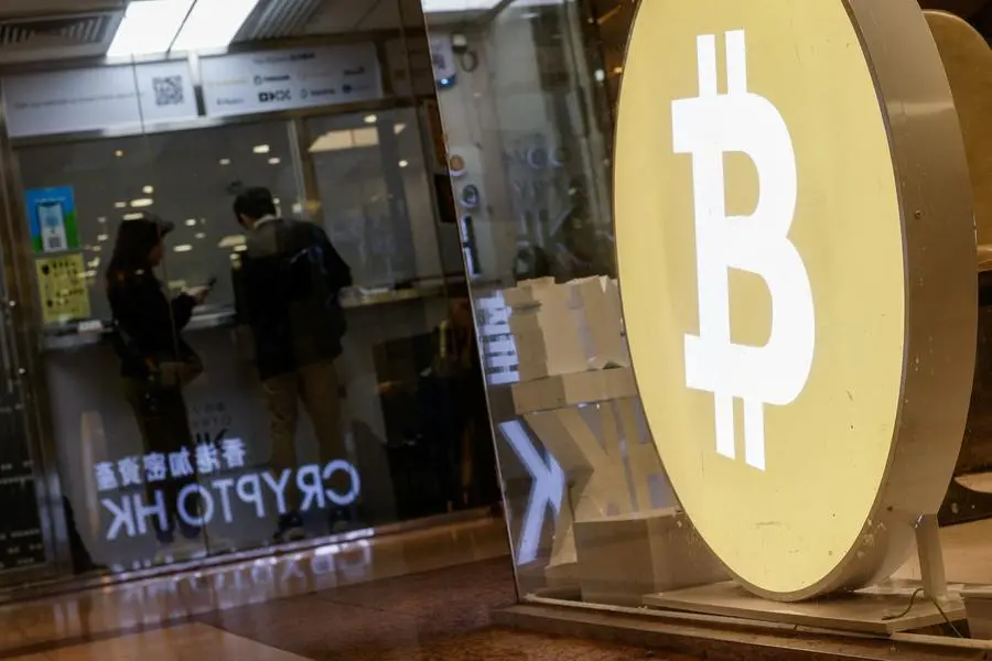 Customers stand at a cryptocurrency exchange store after Bitcoin soars above $100,000, in Hong Kong, China December 5, 2024. REUTERS/Tyrone Siu. , Reuters