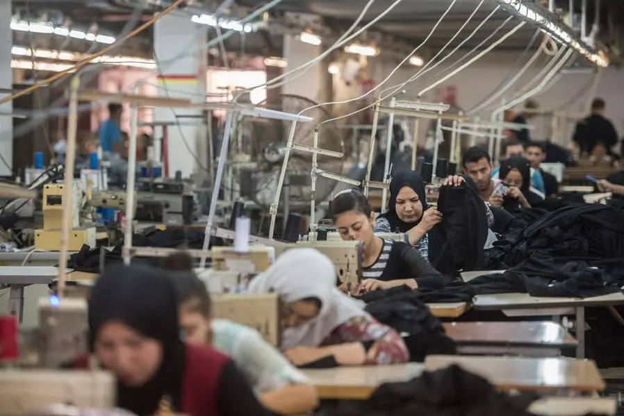 A picture taken on July 29, 2018 shows a tailors sewing at the Marie Louis textile clothing and textile factory in the 10th of Ramadan city, about 60 kms north of Cairo. (Photo by Khaled DESOUKI / AFP). Image used for illustrative purpose.