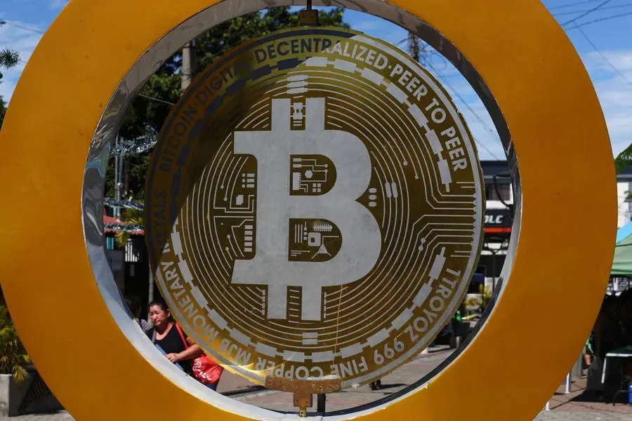 A woman passes by the Bitcoin Monument after bitcoin soared above $100,000, in Ilopango, El Salvador, December 5, 2024. REUTERS/Jose Cabezas. , Reuters