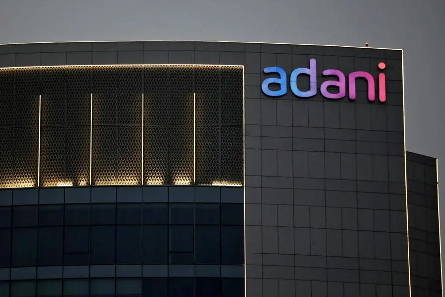 FILE PHOTO: The logo of the Adani Group is seen on the facade of one of its buildings on the outskirts of Ahmedabad, India, April 13, 2021. REUTERS/Amit Dave. , Reuters