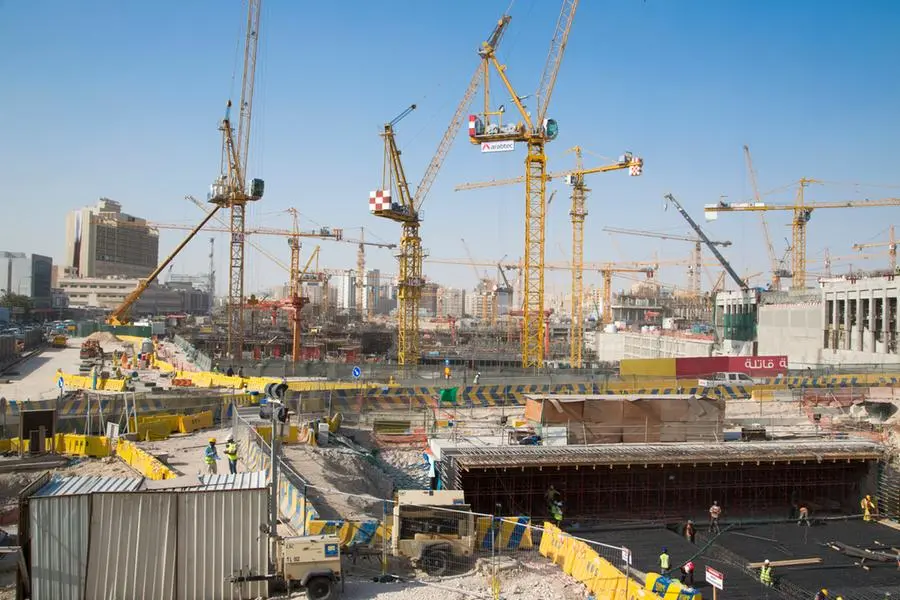 Doha, Qatar --- Cranes and workers at construction site near Souq Waqif. Image courtesy: Holger Leue/Corbis - Getty Images , Getty Images