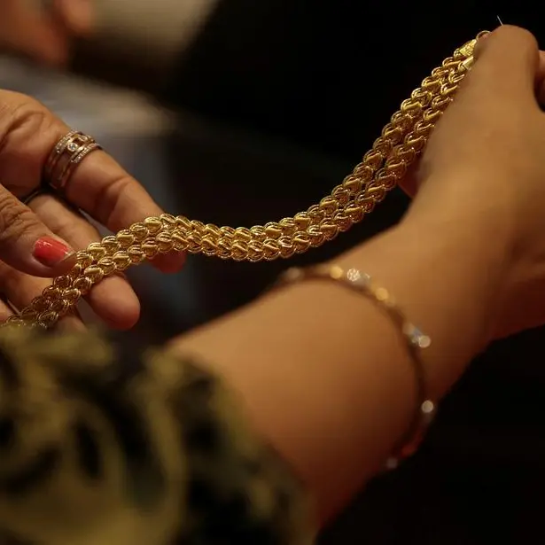 Gold ticks higher as dollar eases; Iran deal hopes temper oil, inflation concerns